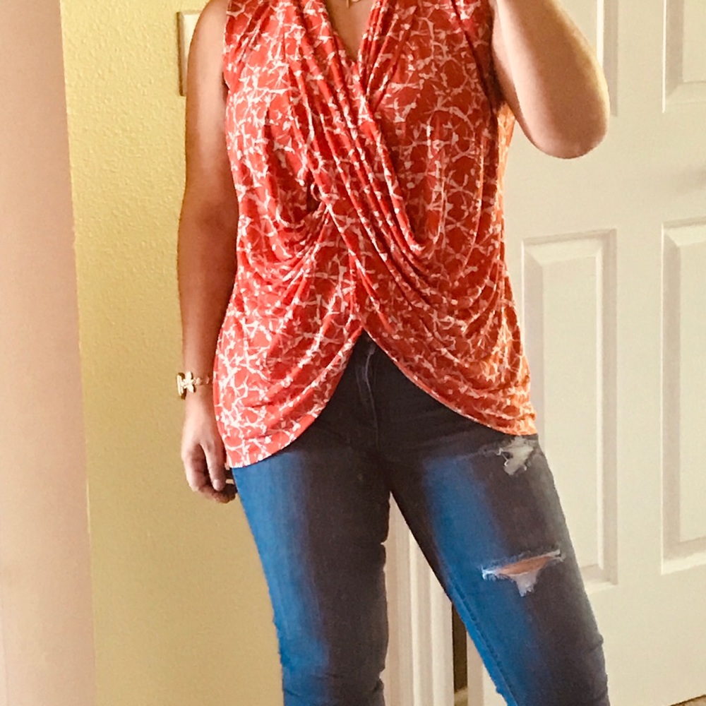 Sleeveless cross front draped blouse.